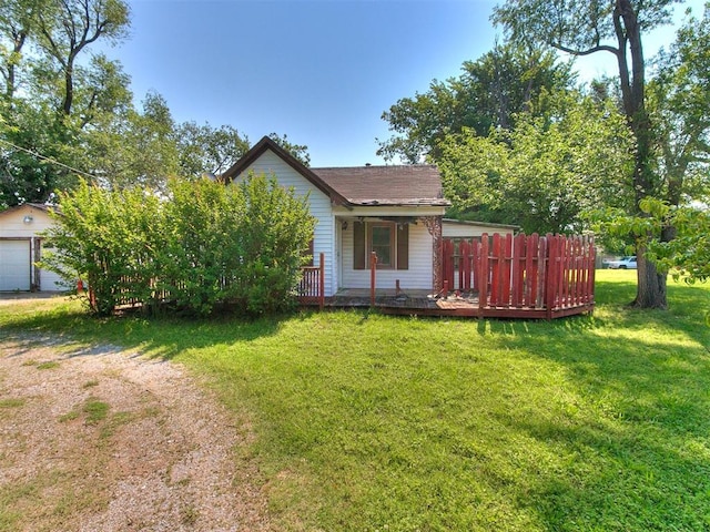 view of side of home with an outdoor structure, a garage, and a yard