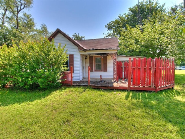 rear view of house featuring a lawn