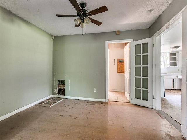 spare room featuring a textured ceiling and ceiling fan