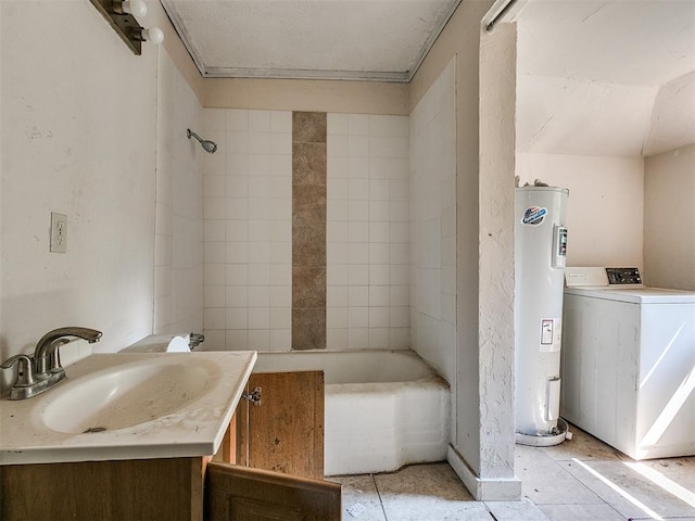 bathroom with washer / dryer, vanity, tiled shower / bath combo, and water heater