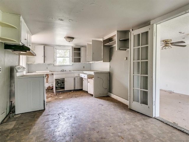 kitchen with ceiling fan, stove, white cabinets, and washer / dryer