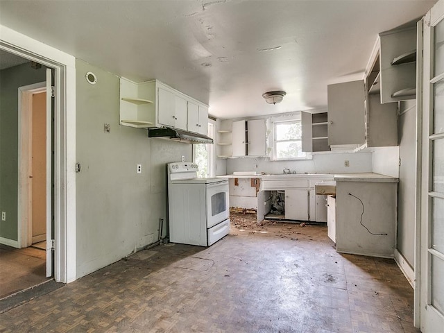 kitchen featuring electric stove, white cabinetry, and sink