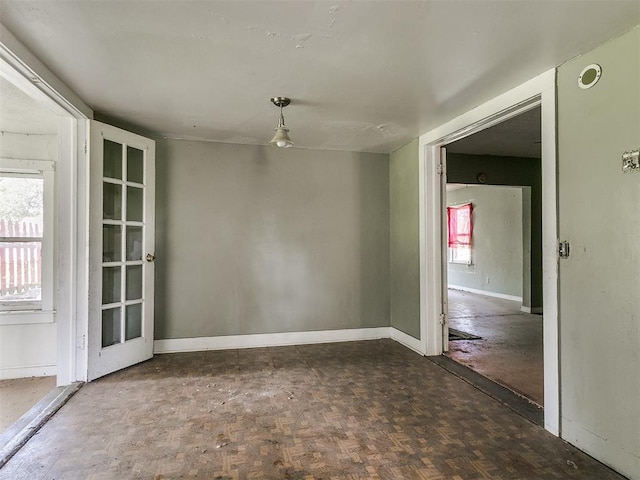 spare room featuring dark parquet floors