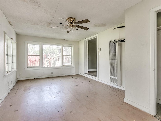 unfurnished sunroom with ceiling fan