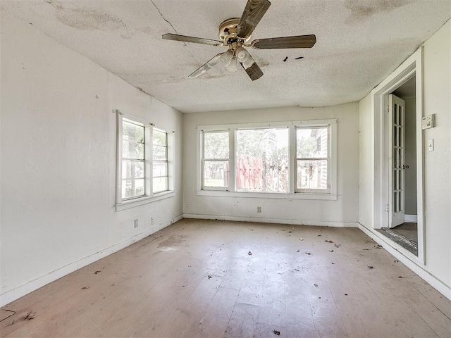 empty room featuring a textured ceiling and ceiling fan