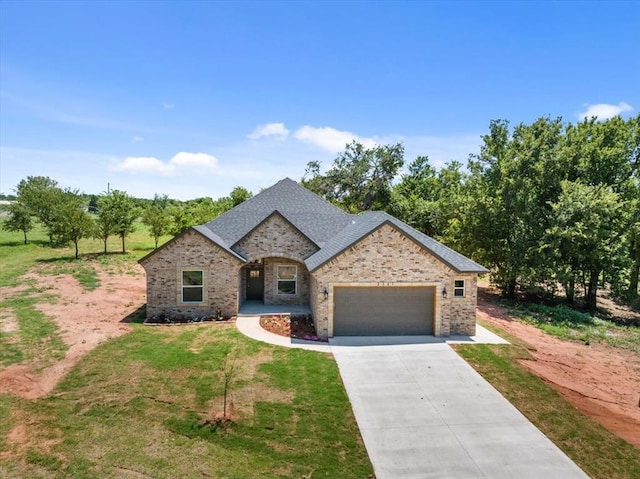 view of front of house with a garage and a front yard