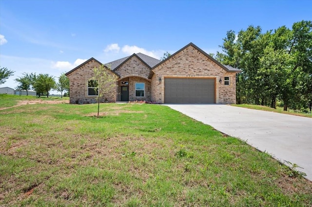 view of front of home with a front yard and a garage