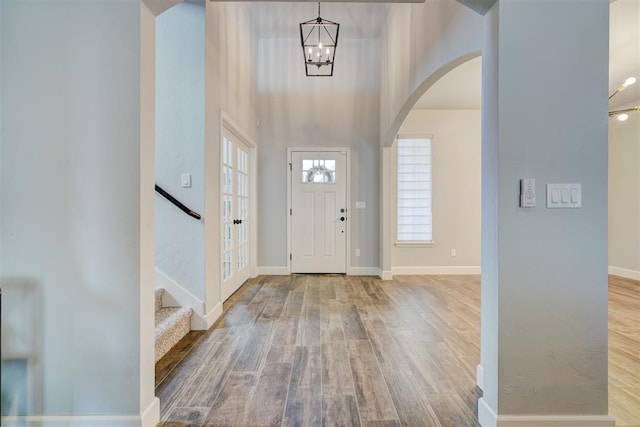 foyer with an inviting chandelier and light hardwood / wood-style flooring