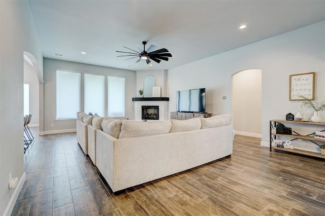 living room with hardwood / wood-style floors and ceiling fan