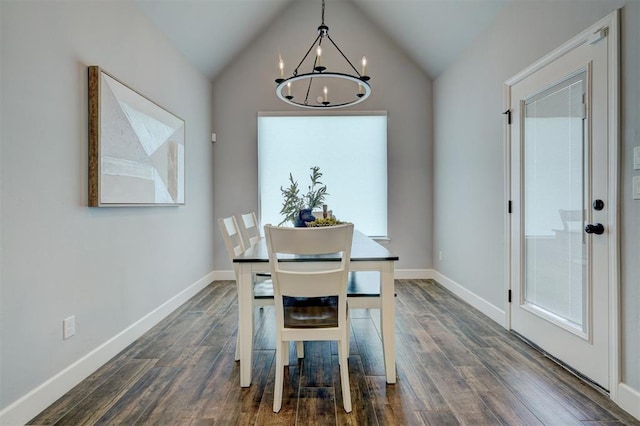 dining room featuring dark hardwood / wood-style floors, a chandelier, and vaulted ceiling