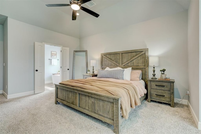 carpeted bedroom with ceiling fan and ensuite bath