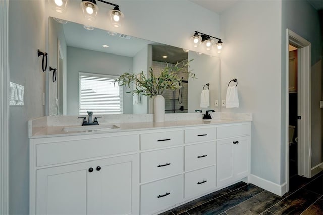 bathroom with wood-type flooring and vanity