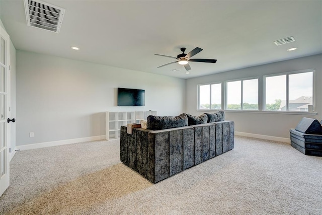 living room featuring ceiling fan and light colored carpet