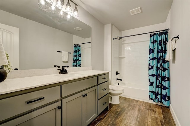 full bathroom with hardwood / wood-style floors, vanity, toilet, and shower / tub combo