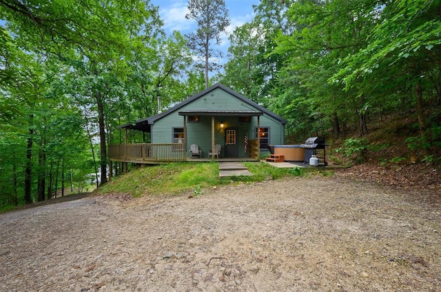 view of front of house featuring a deck and a hot tub