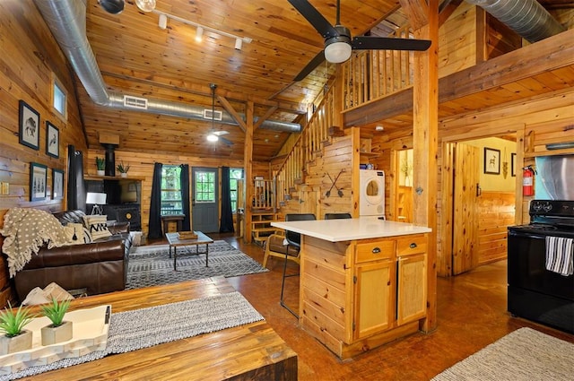 kitchen featuring a center island, high vaulted ceiling, black electric range oven, and wooden walls