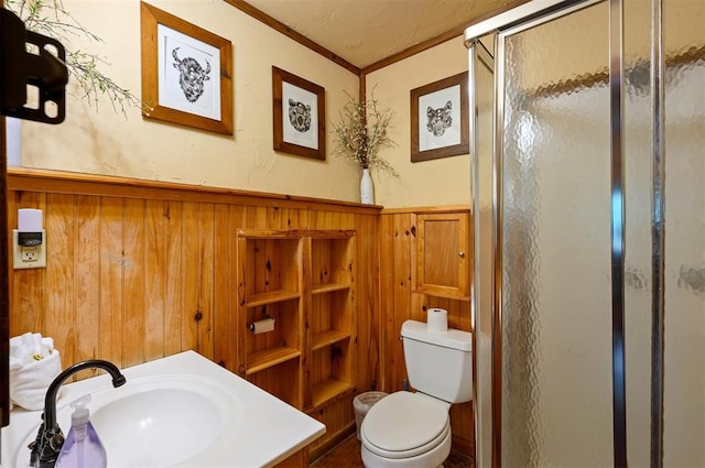 bathroom featuring wood walls, an enclosed shower, toilet, vanity, and ornamental molding