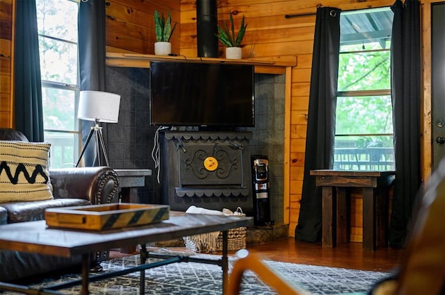 sitting room featuring wood walls and hardwood / wood-style floors