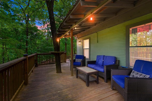 deck at dusk with an outdoor living space