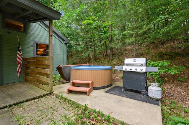 view of patio / terrace with grilling area and a hot tub