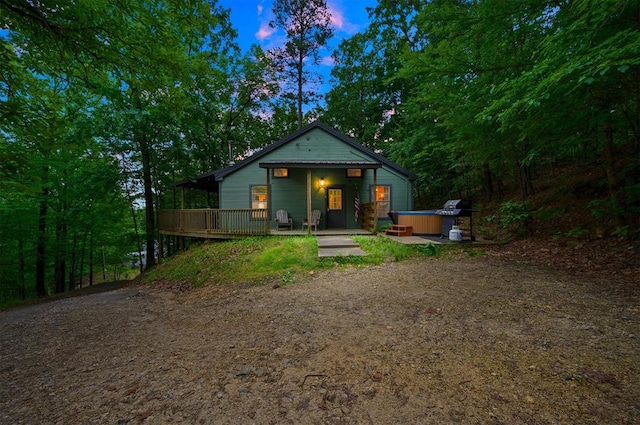 view of front of house featuring a wooden deck and a hot tub