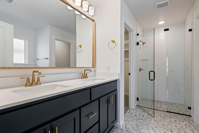 bathroom featuring vanity and an enclosed shower