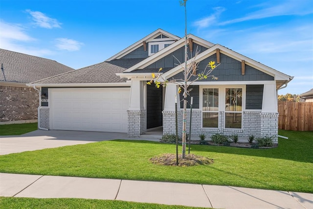 craftsman inspired home featuring a garage and a front lawn