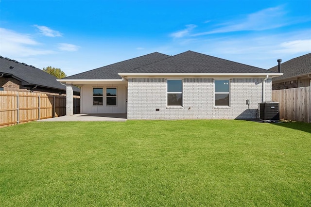 back of property featuring a lawn, cooling unit, and a patio