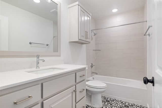 full bathroom featuring vanity, tiled shower / bath combo, and toilet