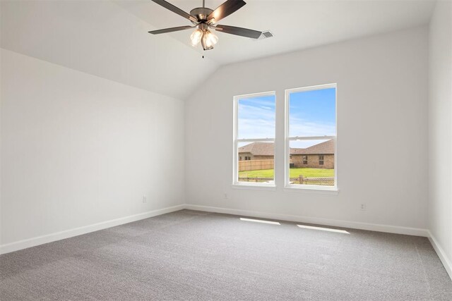 empty room featuring ceiling fan, carpet floors, and lofted ceiling