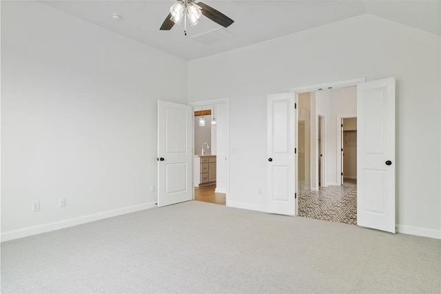 unfurnished bedroom featuring ceiling fan, light carpet, and lofted ceiling