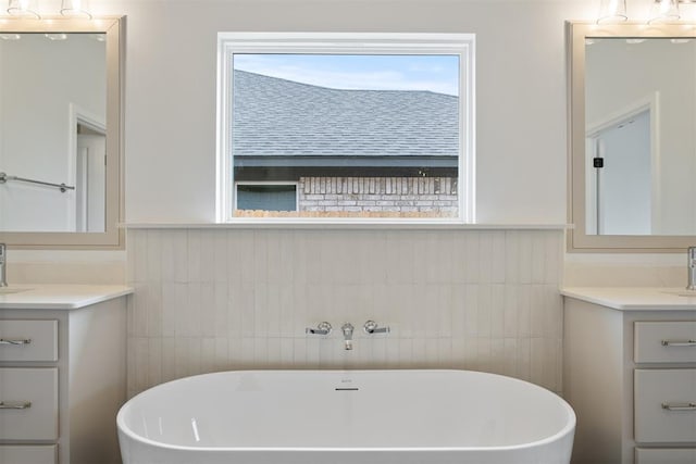 bathroom featuring a bathtub, tile walls, and vanity