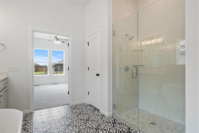 bathroom featuring tile patterned flooring, vanity, a shower with door, and ceiling fan