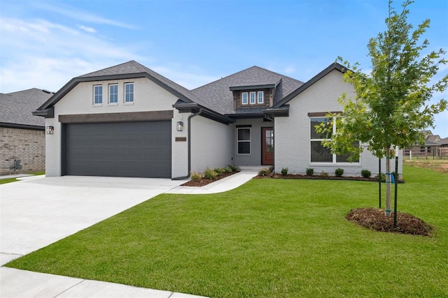 view of front of property with a front lawn and a garage