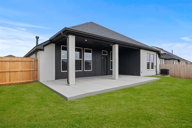 back of house with a lawn, a patio area, and central air condition unit