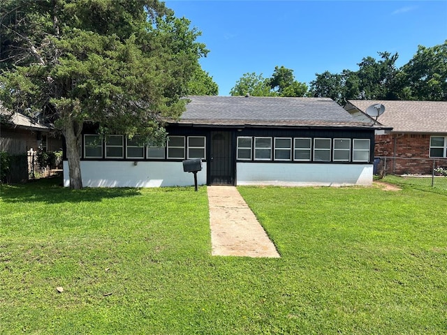 ranch-style home with a front lawn