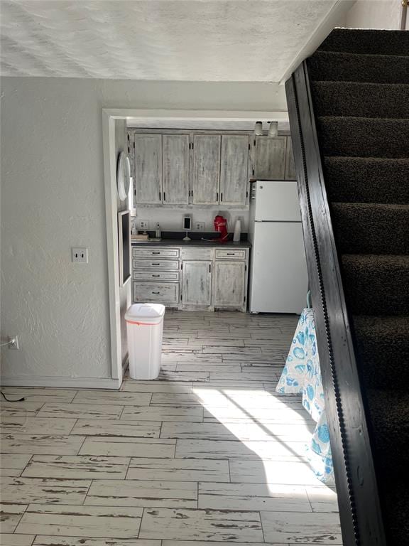 kitchen with white fridge and light hardwood / wood-style floors