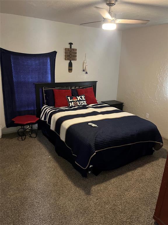 bedroom with ceiling fan and carpet floors