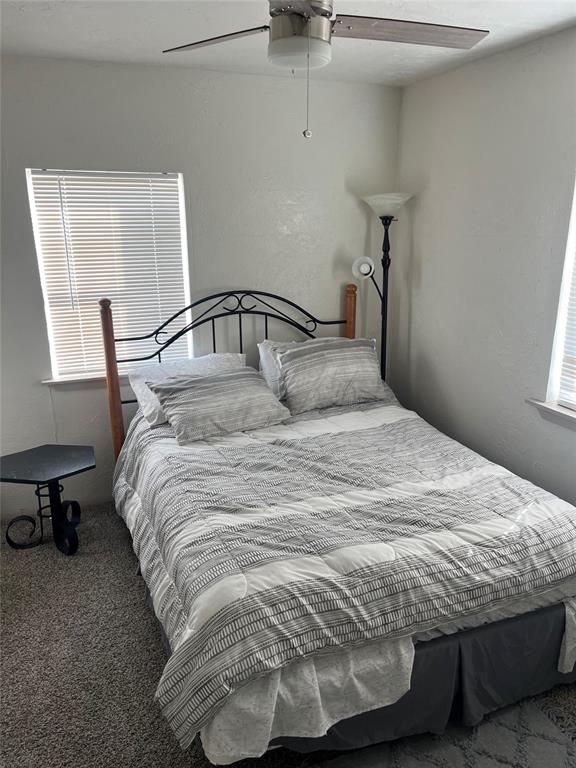 carpeted bedroom featuring ceiling fan