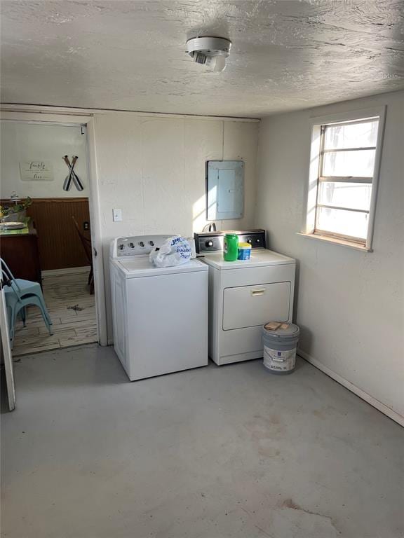 laundry area with electric panel and independent washer and dryer