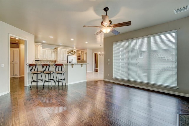 living room featuring ceiling fan and dark hardwood / wood-style flooring