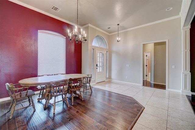 dining room featuring a chandelier, crown molding, and light hardwood / wood-style floors