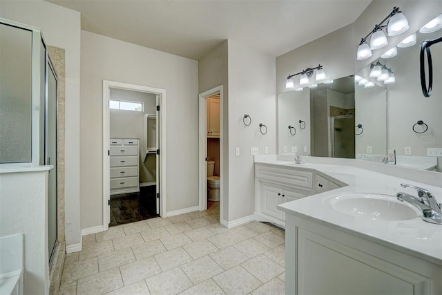 bathroom featuring tile patterned floors, vanity, and a shower with shower door