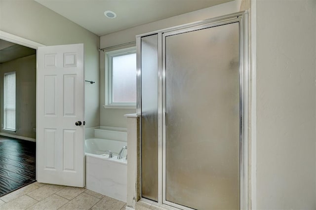 bathroom with hardwood / wood-style flooring and separate shower and tub