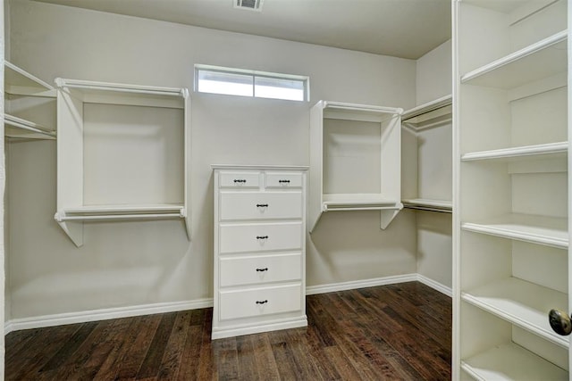 walk in closet with dark hardwood / wood-style floors