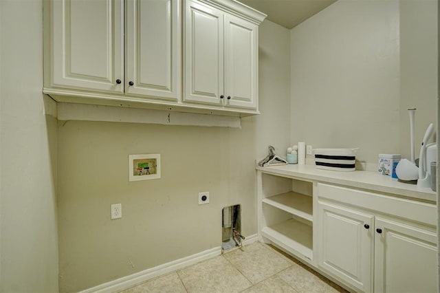 clothes washing area featuring cabinets, light tile patterned floors, hookup for a washing machine, and electric dryer hookup