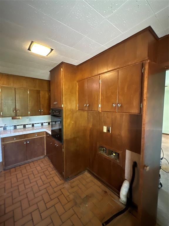 kitchen with wooden walls and oven