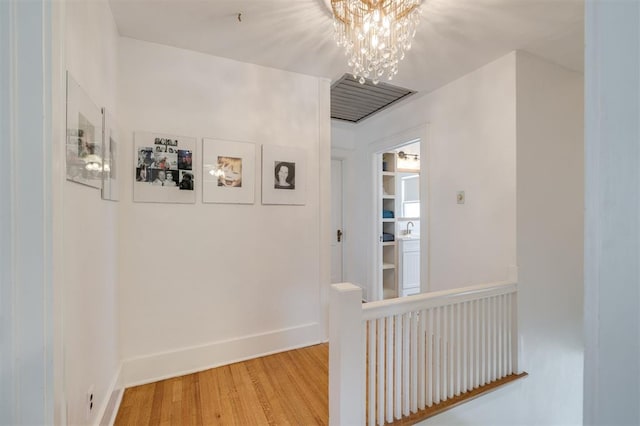 hallway featuring a chandelier and hardwood / wood-style floors