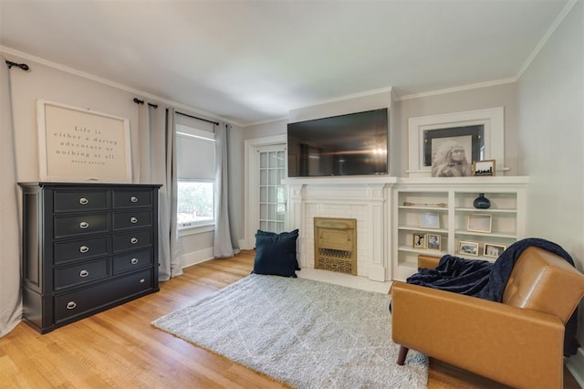 sitting room with hardwood / wood-style floors and ornamental molding