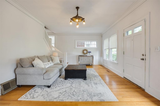 living room with crown molding, plenty of natural light, and wood-type flooring